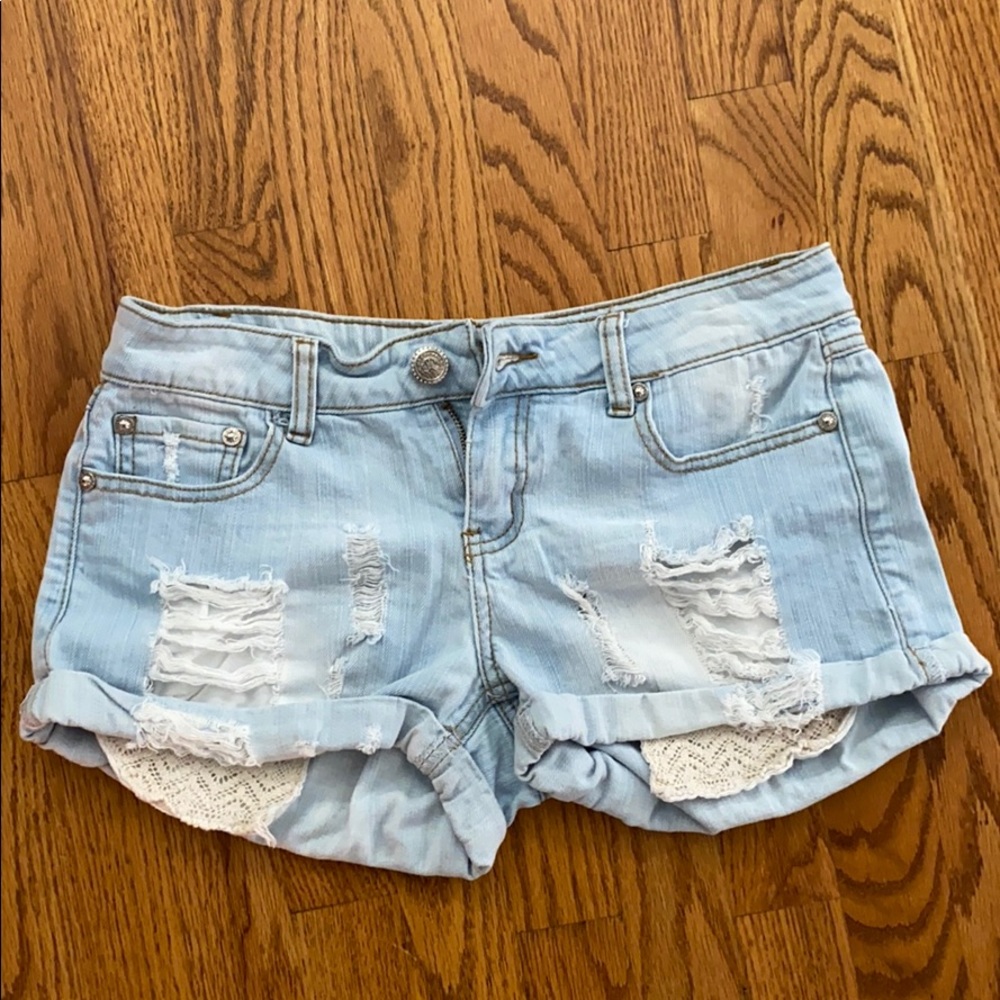 Light washed ripped denim shorts w/ lace pockets